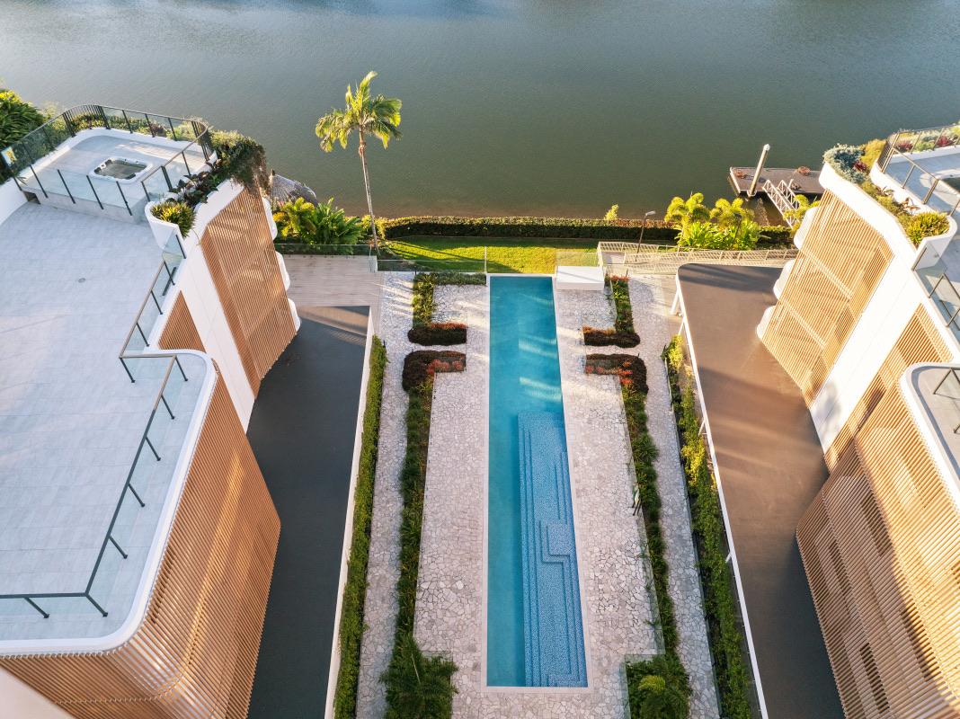 KOKOMO completed project, with the pool extending along the central landscape axis towards the river.